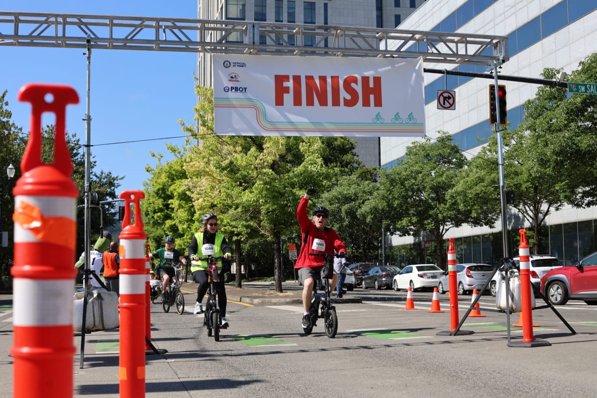 Large group of riders on electric bikes gathered along Portland waterfront for world record attempt
