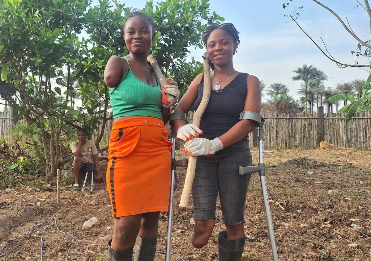 Amputee farmers working together on sustainable agriculture training farm in Sierra Leone