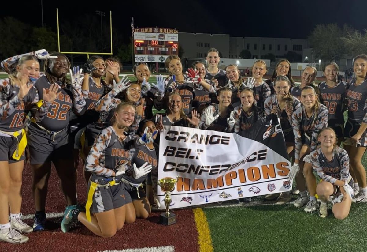 High school flag football players celebrate championship victory on field after overtime win