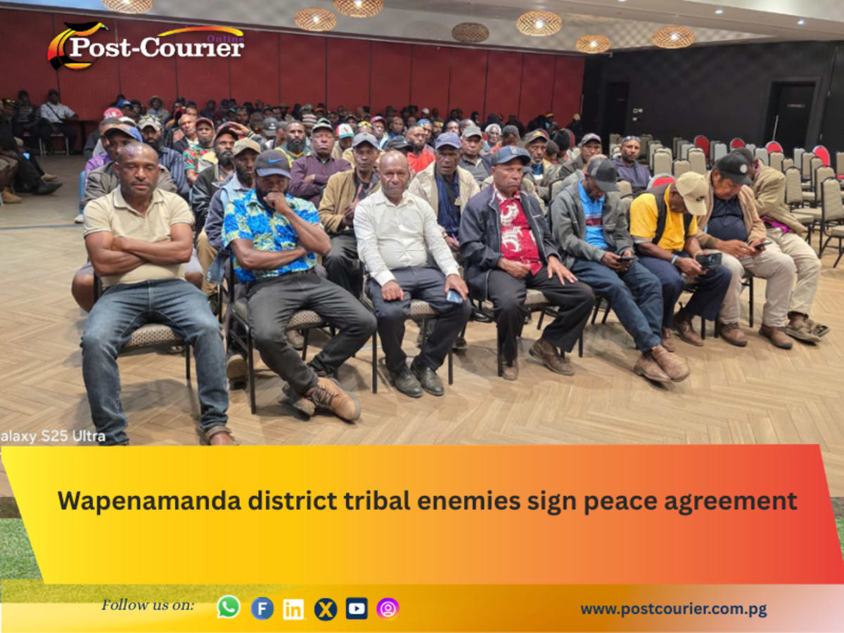 Tribal leaders shaking hands during historic peace agreement signing ceremony in Papua New Guinea