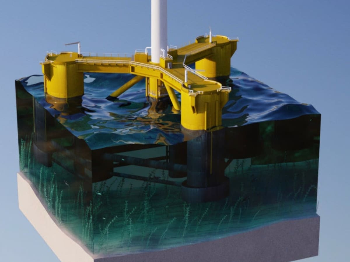 Large wind turbine mounted on floating ocean platform with stabilizing columns in deep blue water