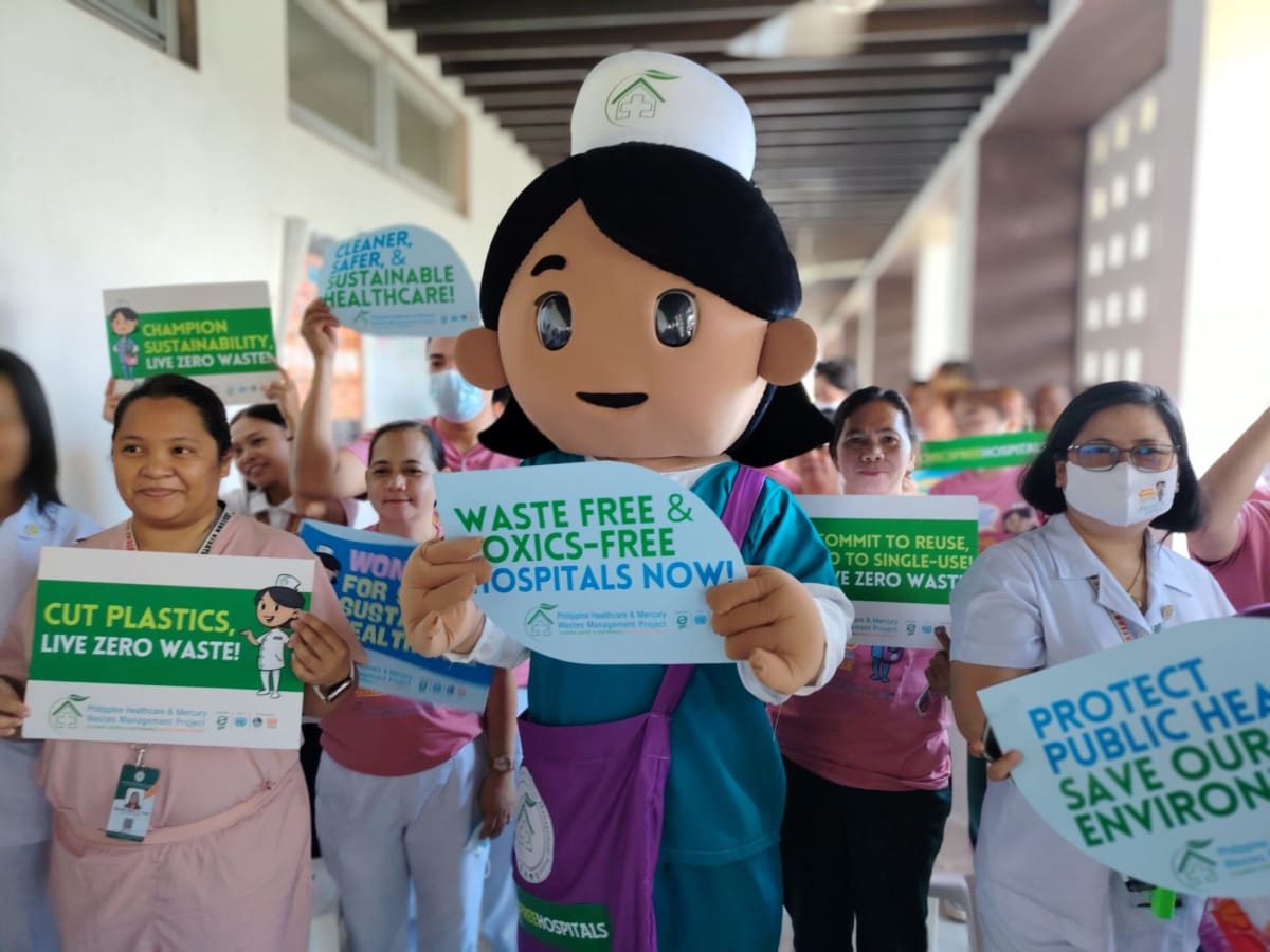 Nurse Susie mascot character in hospital promoting plastic waste reduction and reusable items