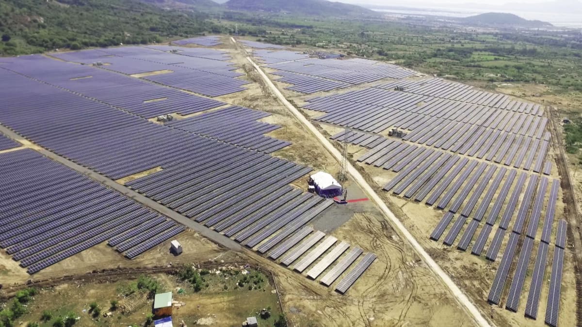Solar panels and battery storage facilities under blue sky in India generating clean electricity