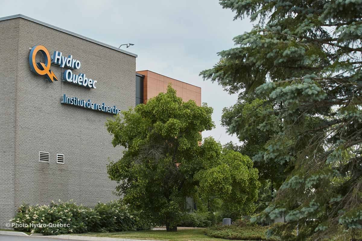 Solar panels installed on residential rooftop in Québec with bright blue sky background