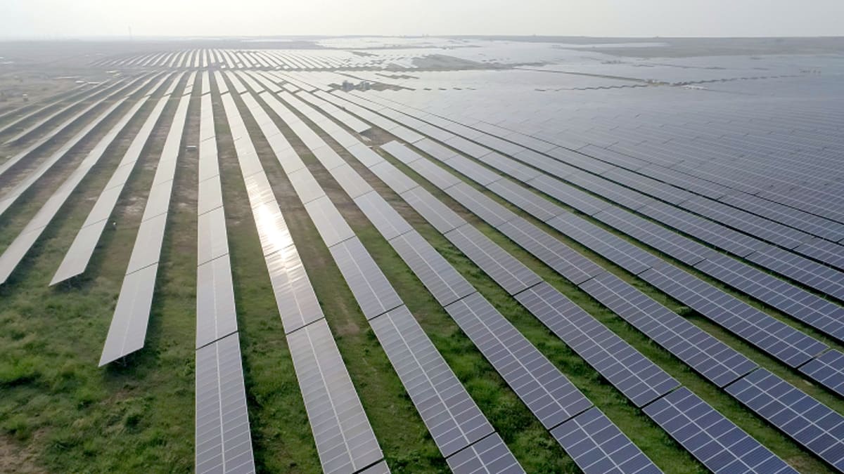 Large solar panel installation with battery storage facilities under bright Indian sunlight