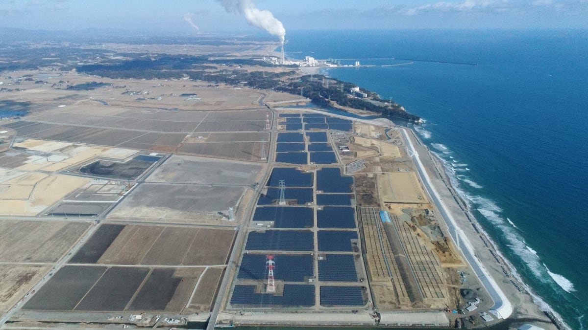 Solar panel arrays gleaming under bright sunlight in Japan countryside landscape