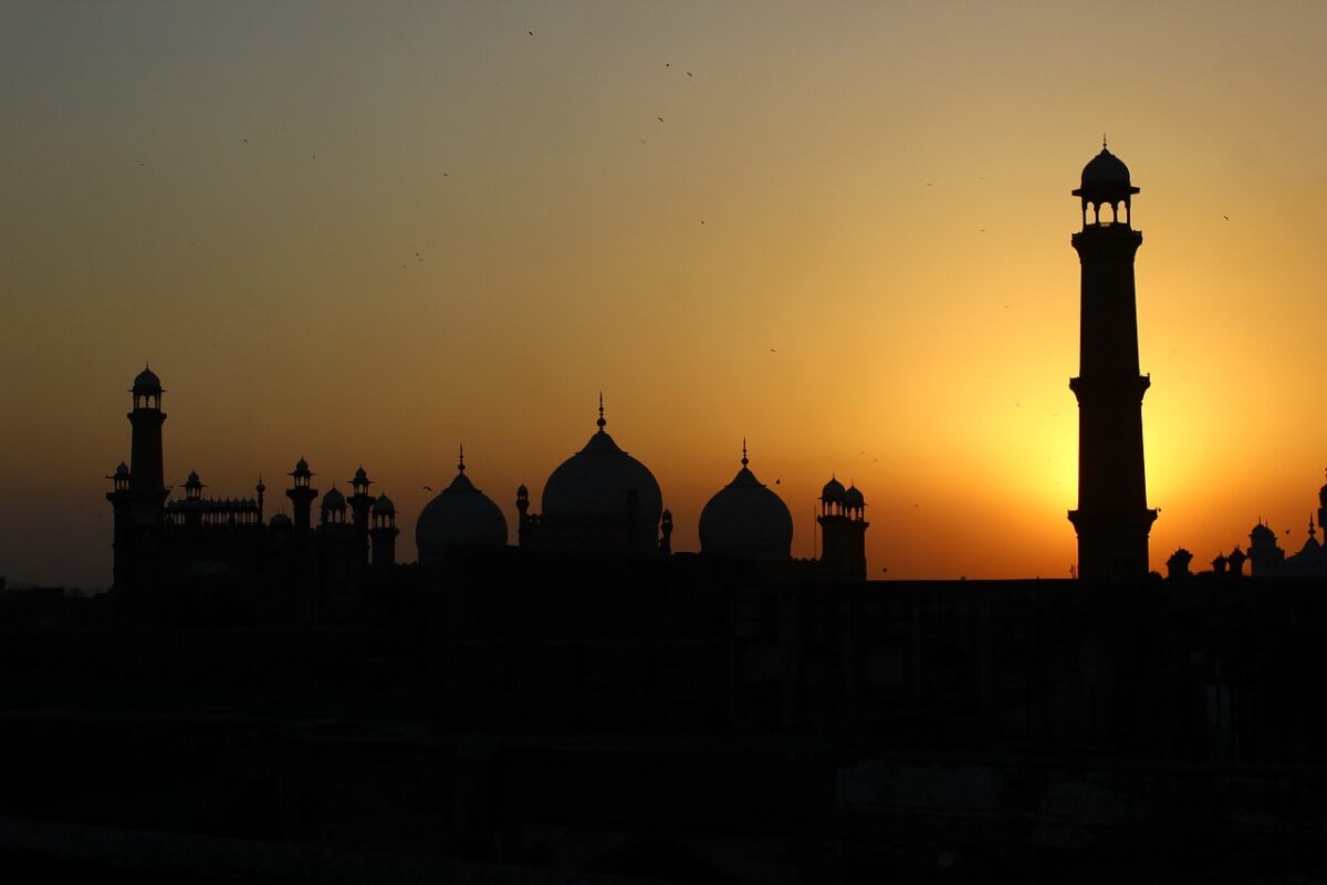 Solar panels installed on residential rooftop in Pakistan under bright blue sky