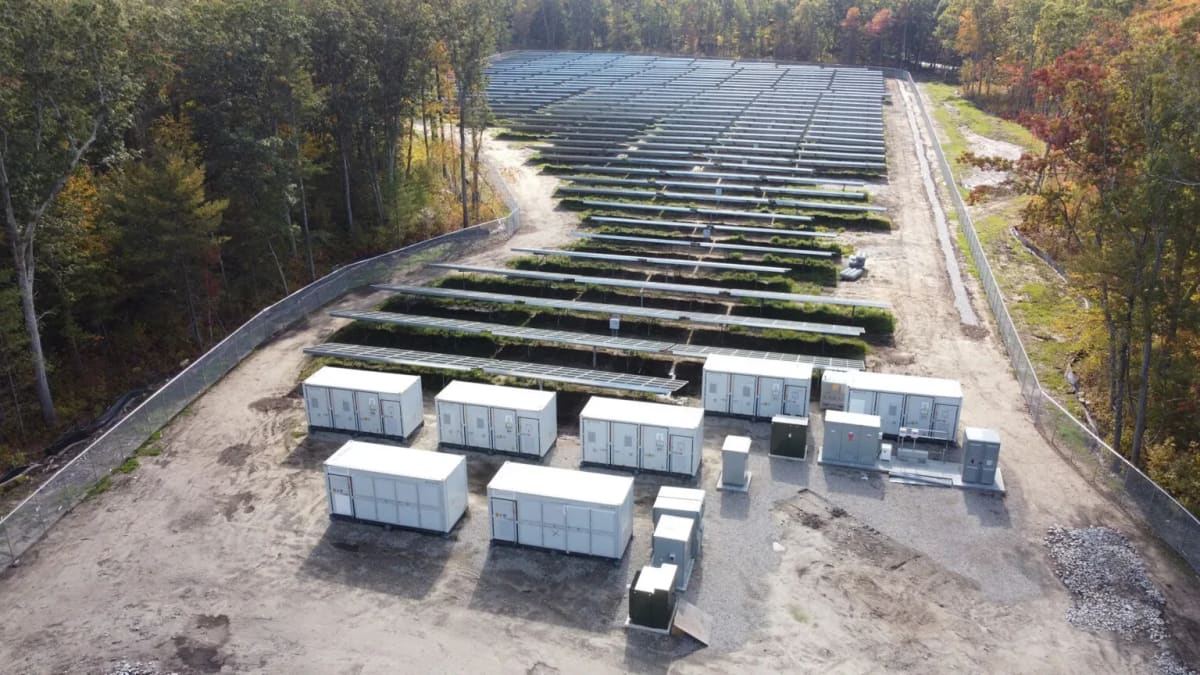Large scale battery energy storage facility with solar panels under clear blue Argentine sky