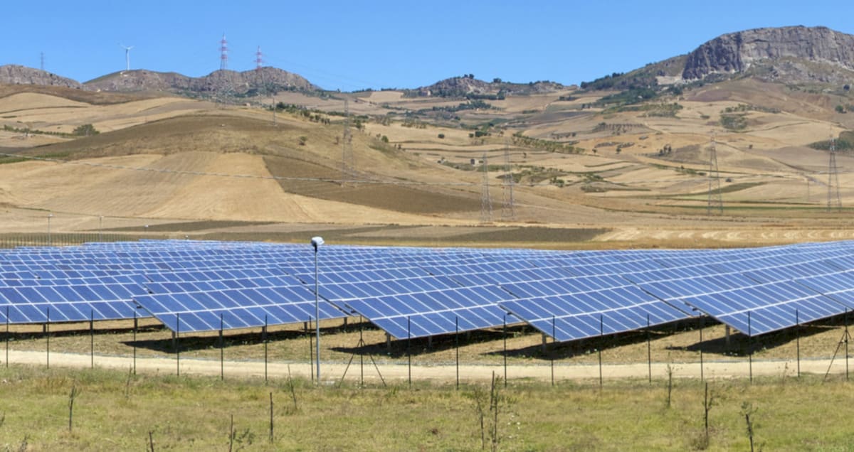 Solar panels installed on rooftop in sunny Italian countryside landscape