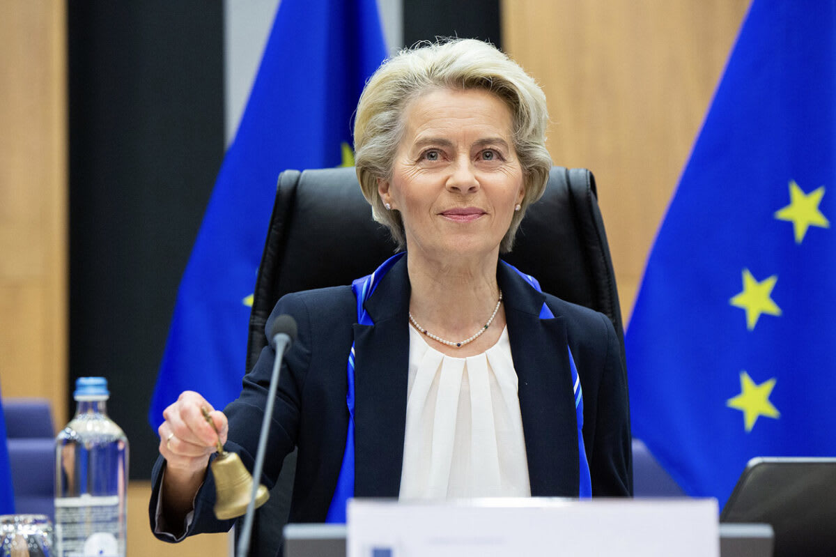 Solar panels and wind turbines generating renewable energy across European countryside landscape