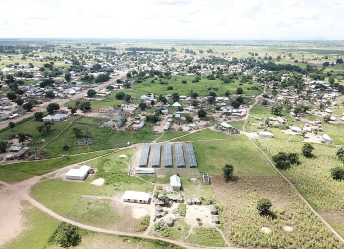 Solar panels with battery storage units bringing electricity to rural West African village