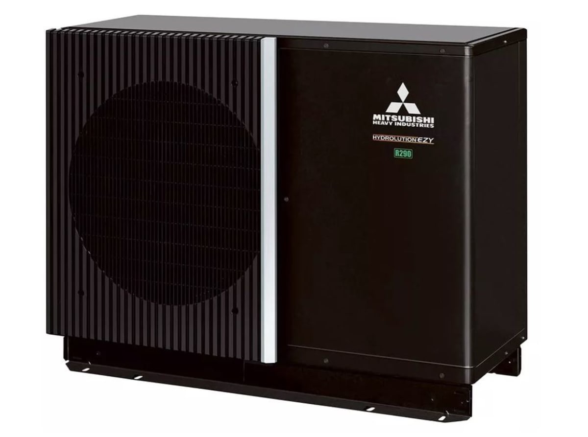 Modern white Mitsubishi heat pump unit installed outside residential building with efficient heating technology
