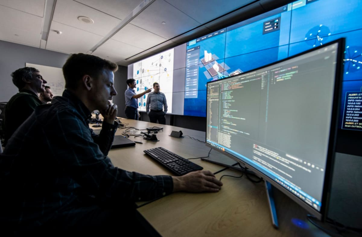 Solar panels with digital security network overlay showing protected grid infrastructure connection