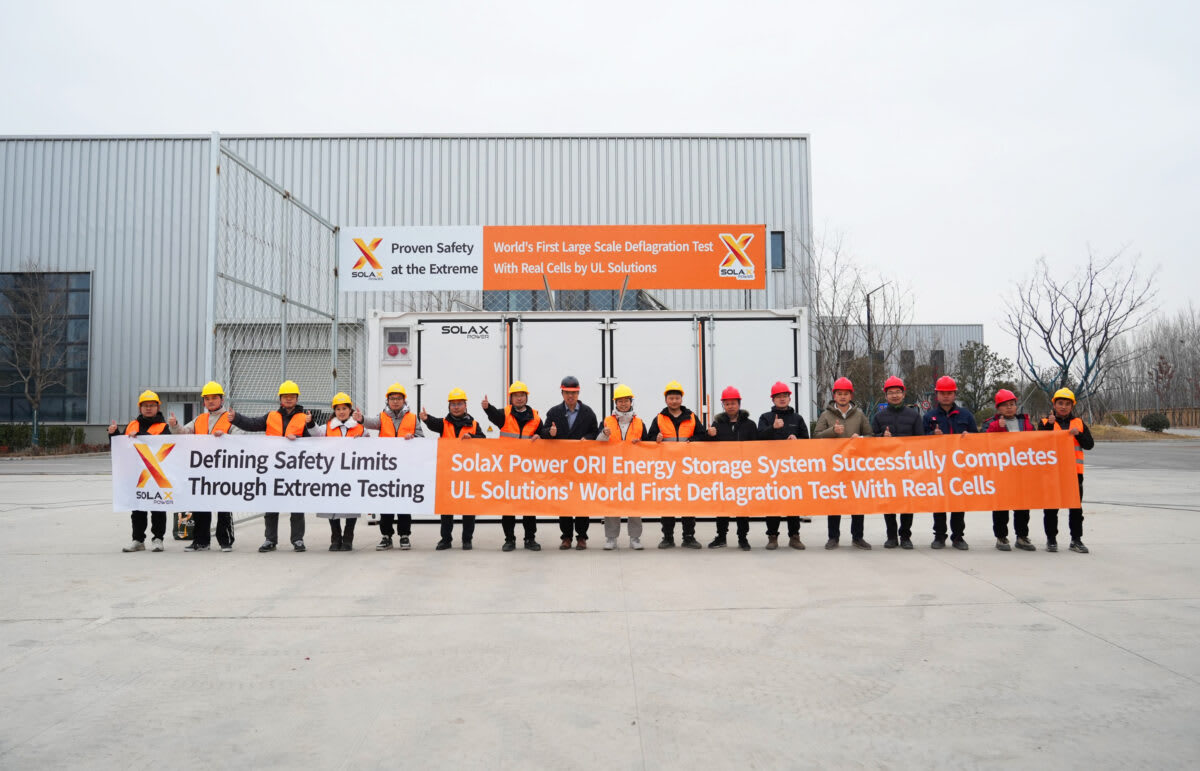 Large white shipping container energy storage system in testing facility with safety monitoring equipment