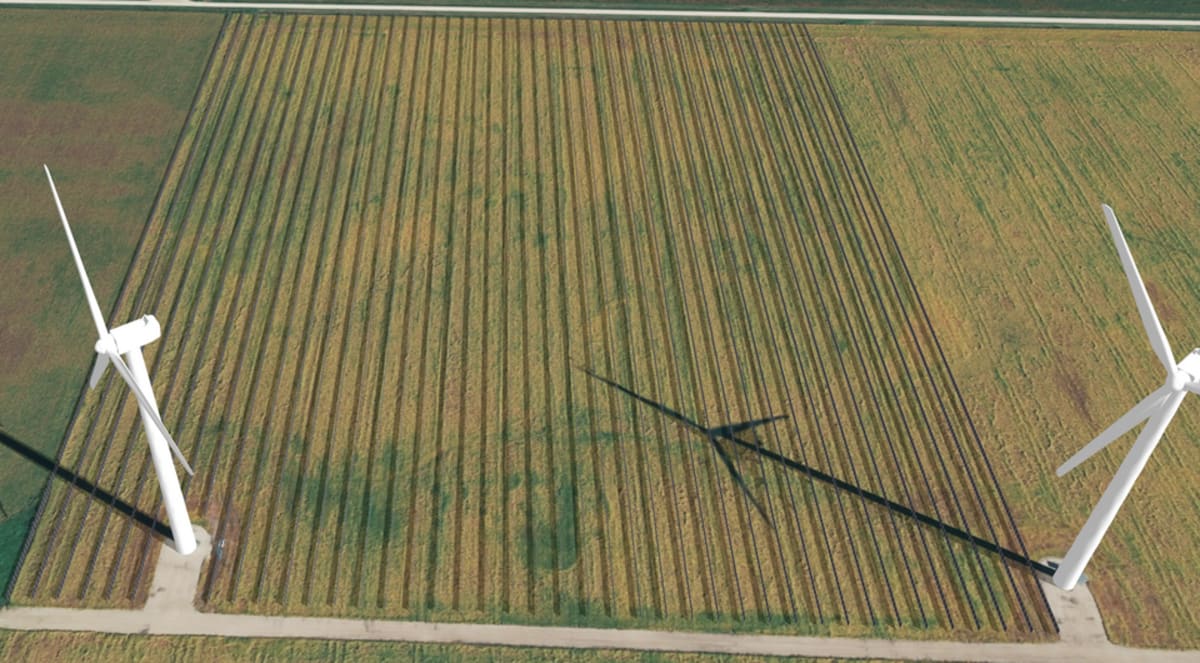 Modern data center facility with solar panel arrays and wind turbines in Irish countryside