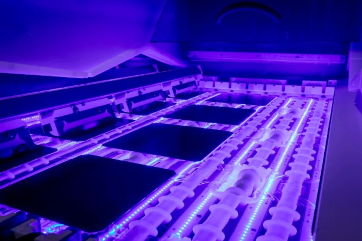 Close-up of blue crystalline solar panel cells with metallic contact grid pattern