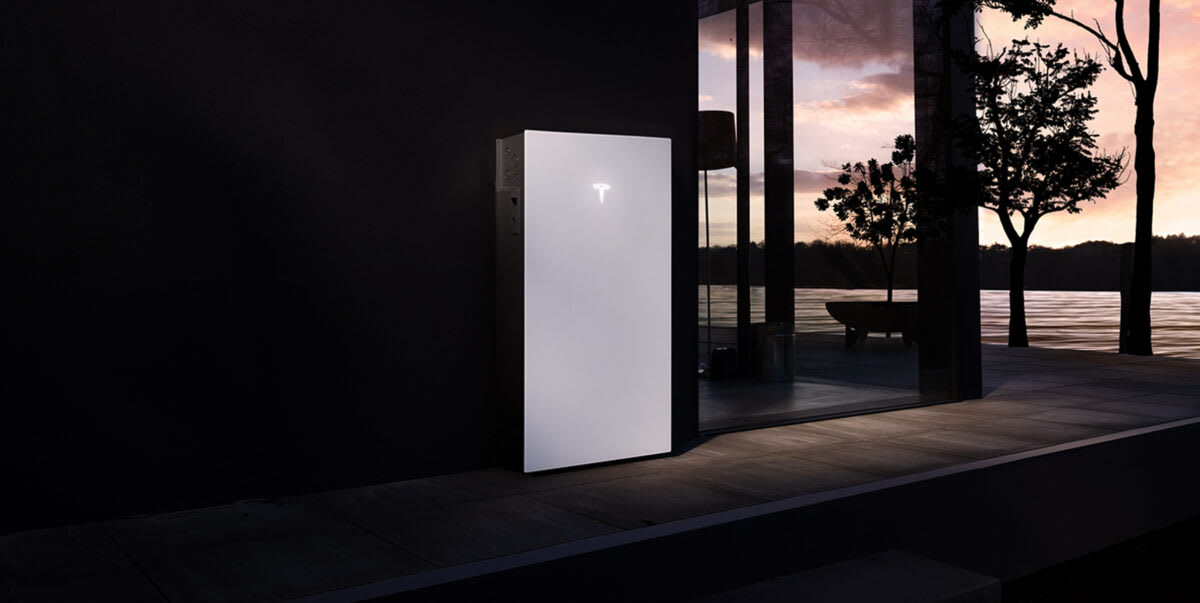 Tesla Powerwall 3P battery system mounted on exterior wall of modern home