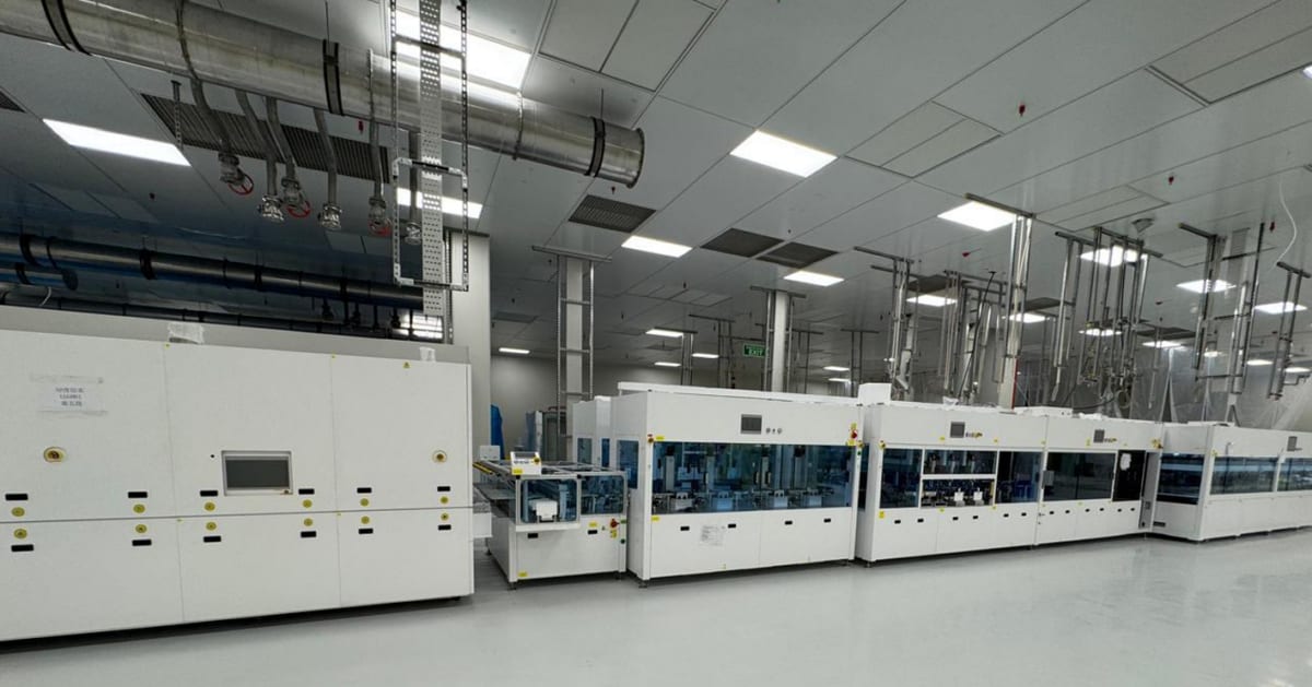 Advanced solar panel cells in manufacturing facility showing blue crystalline photovoltaic technology