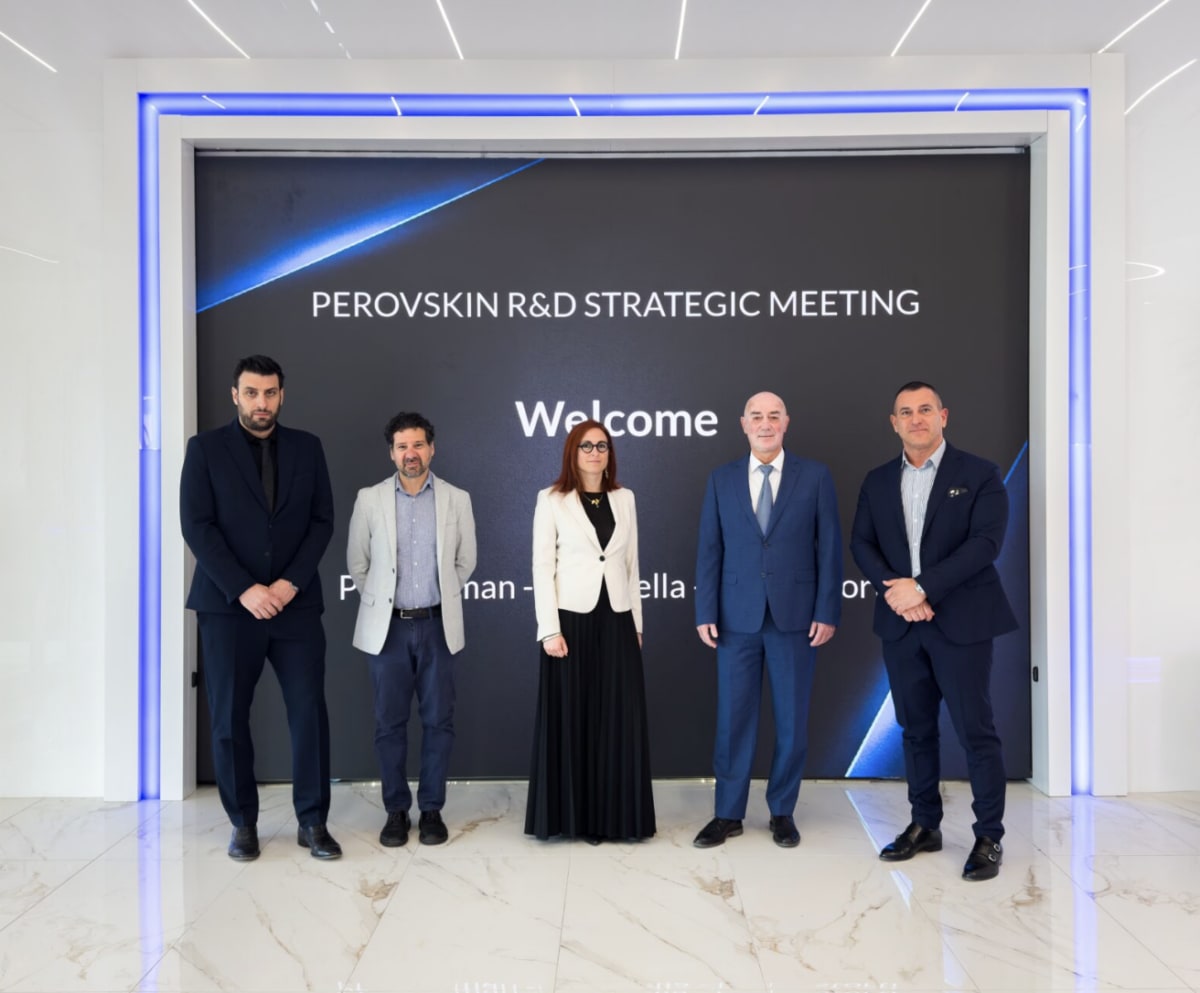 Modern solar panels on industrial building rooftop with Italian countryside in background