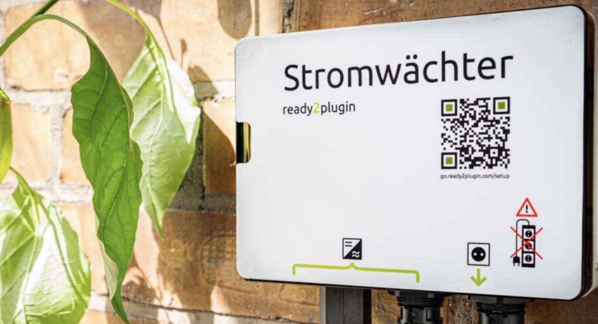 Solar panels installed on apartment balcony railing in German residential building