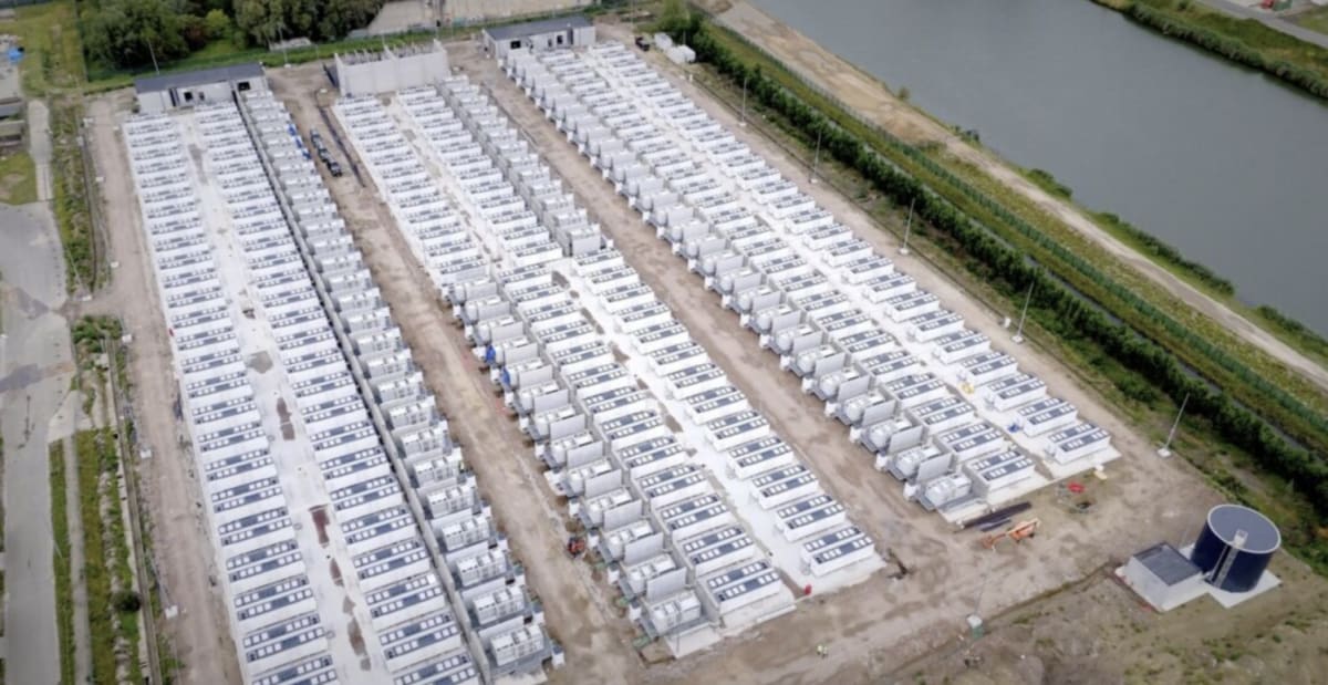 Large battery energy storage facility with solar panels in Argentina landscape under blue sky
