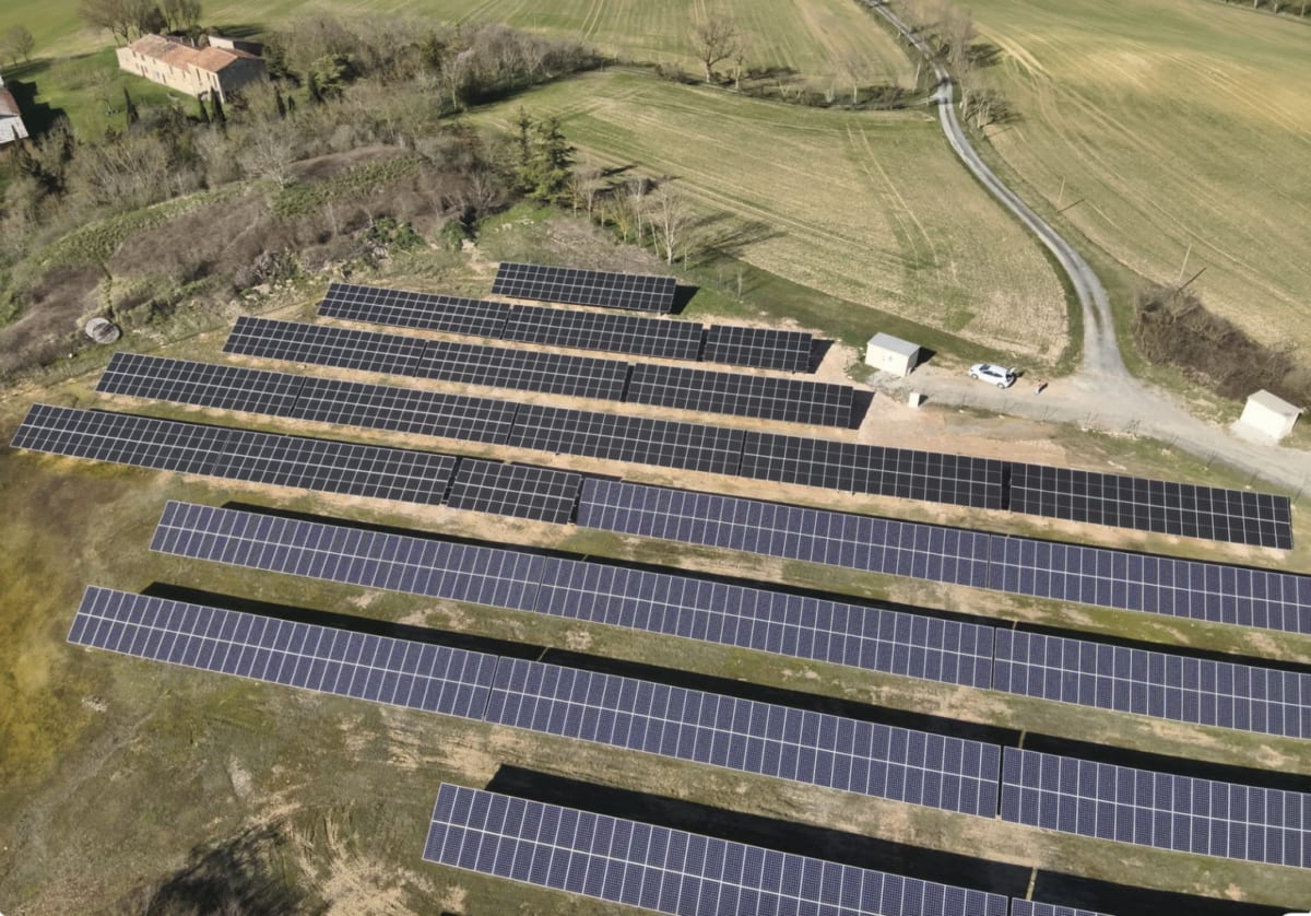 Small-scale solar panel installation connected to local power grid in rural French countryside