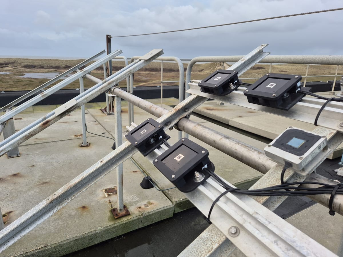 Triple-layer perovskite solar cell panel mounted at angle on outdoor testing station