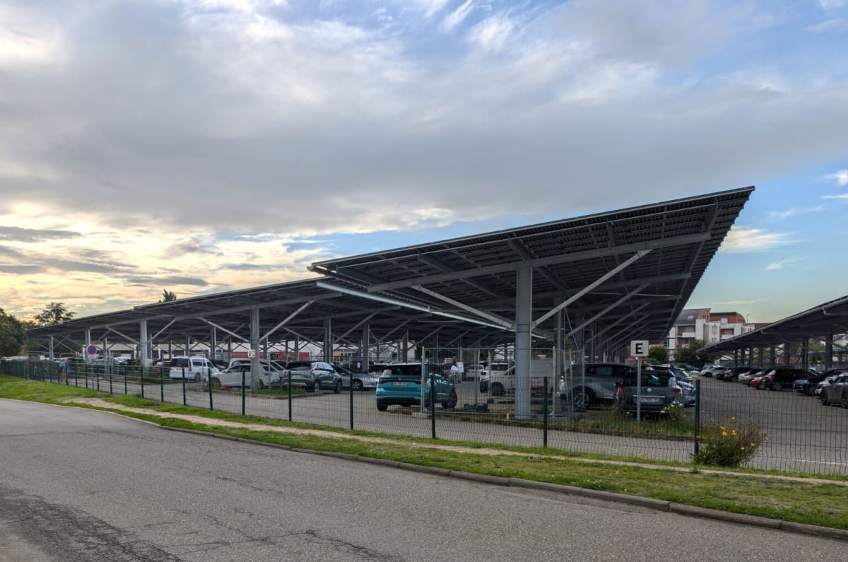 Solar panels installed on commercial building rooftop in France under blue sky