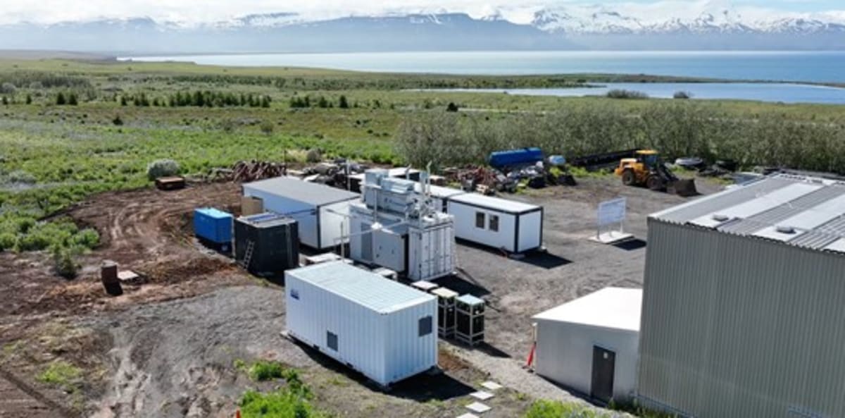 Geothermal hydrogen production facility with steam rising in volcanic landscape of northern Iceland