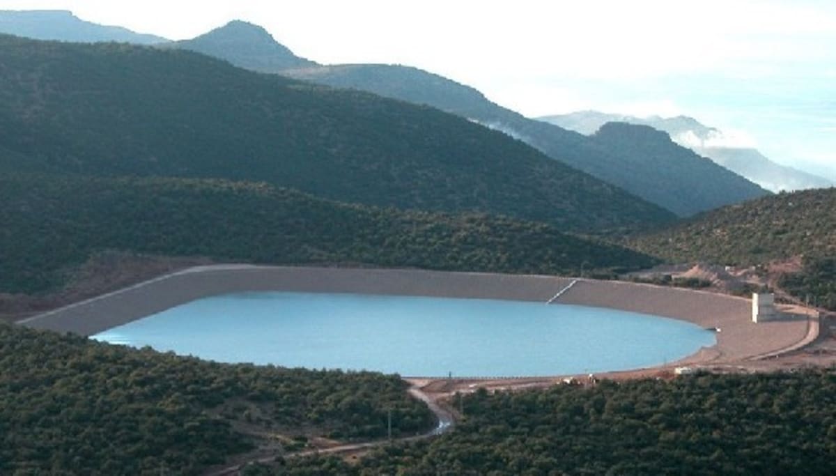 Aerial view of pumped hydropower storage facility with water reservoir in mountainous Moroccan landscape