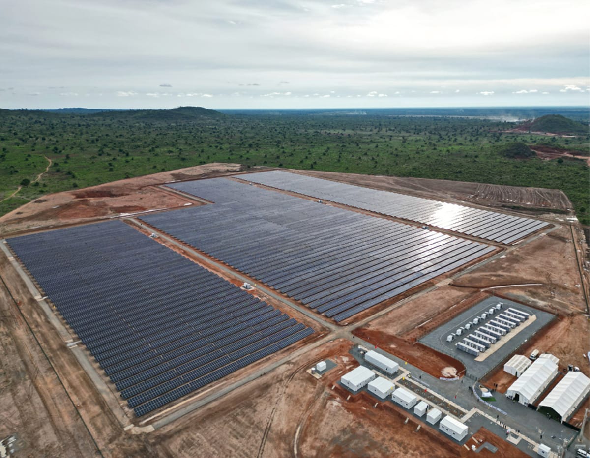 Large solar panel arrays stretching across sunny landscape in rural Angola Africa