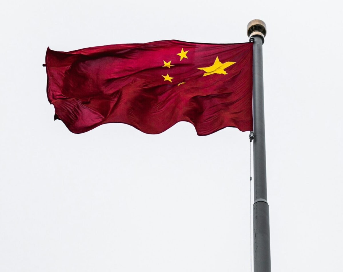 Large-scale lithium battery storage facility with solar panels visible in background in China