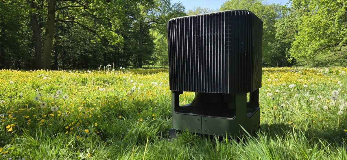 Compact white Whspr heat pump unit installed outside narrow terraced home exterior