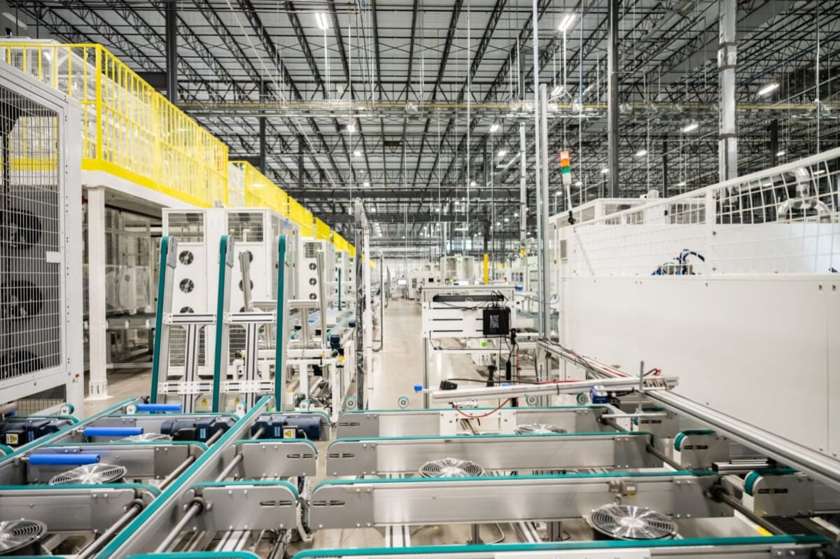 Modern solar panel manufacturing facility with rows of photovoltaic modules in production