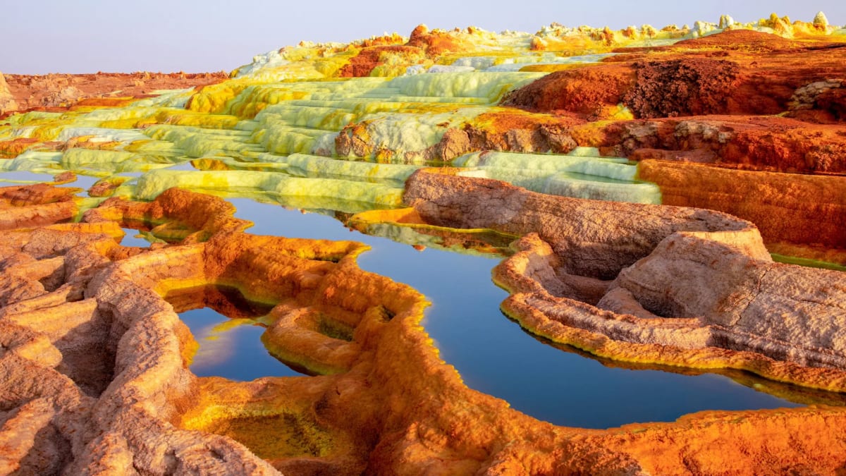 Colorful bacterial mats surrounding steaming hot spring in Yellowstone National Park