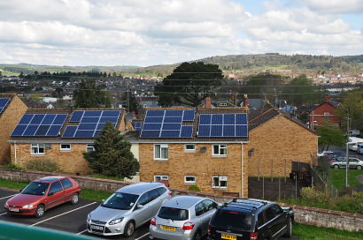 Solar panels installed on residential rooftop with blue sky and sunshine
