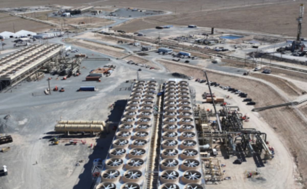 Geothermal power plant facility with steam rising against Utah desert landscape backdrop