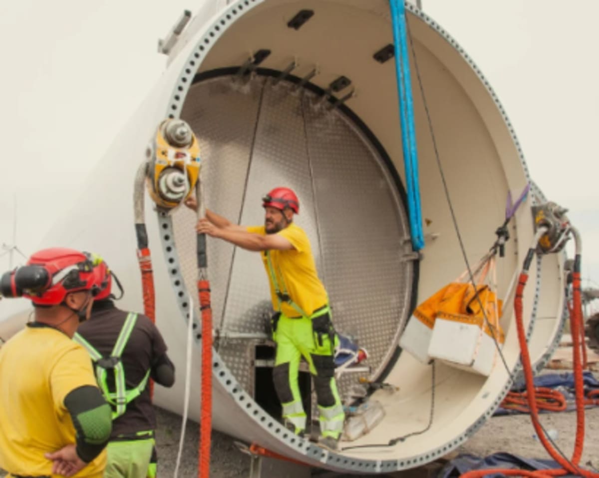 Modern wind turbines against blue sky representing Ukraine's renewable energy future and recovery efforts
