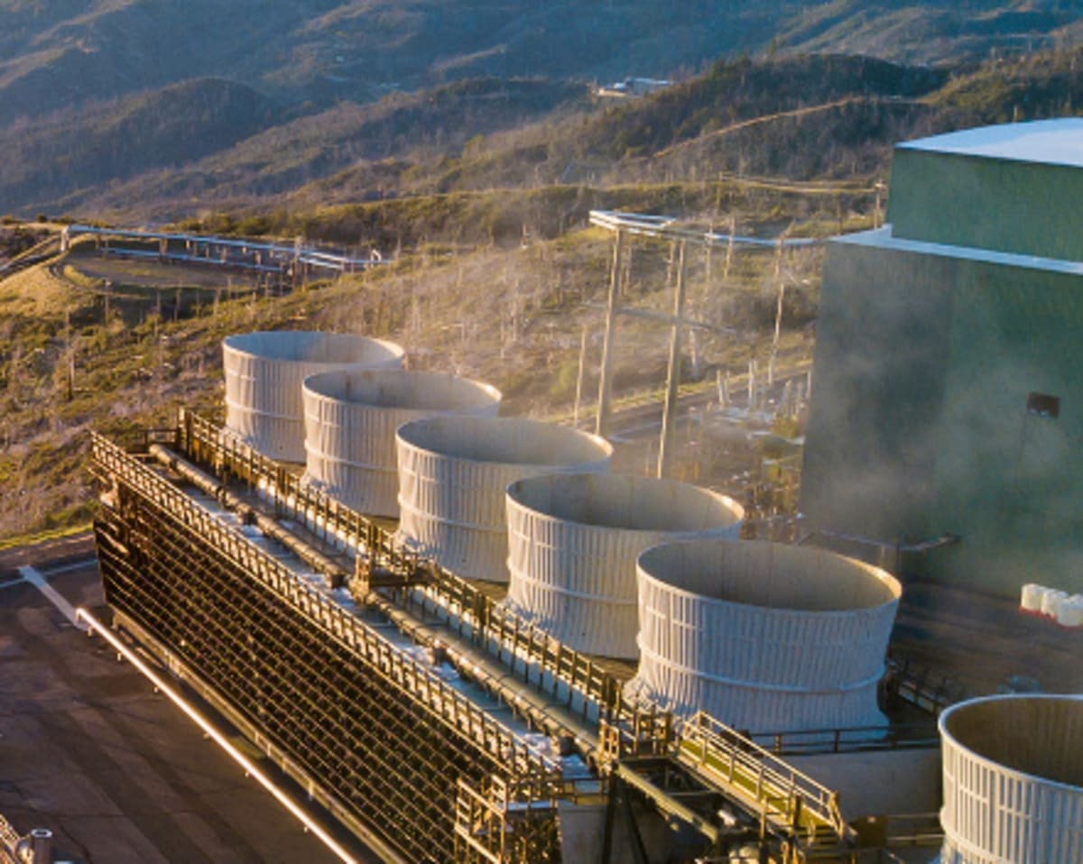 Steam rising from geothermal power plant infrastructure at The Geysers complex in California