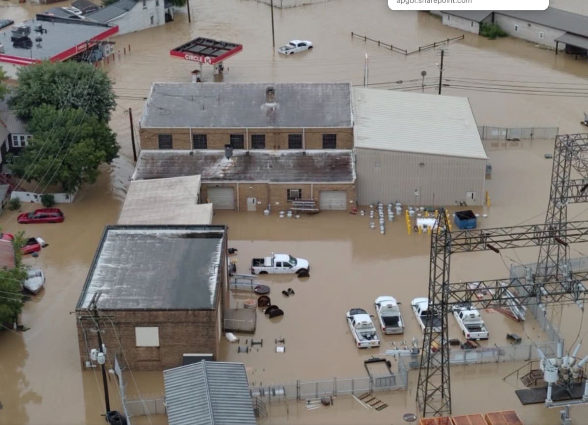 Utility workers repairing power lines and damaged poles after severe Midwest storms