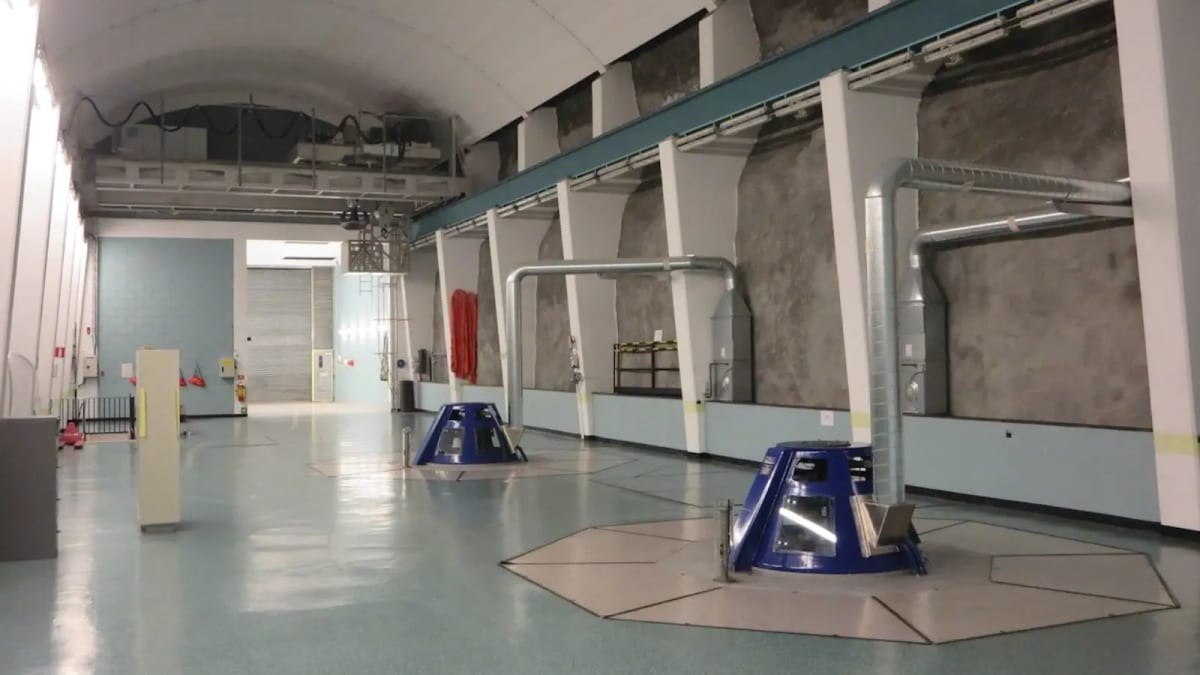 Interior machine hall of Refsdal hydropower plant showing large turbine generators in Norway