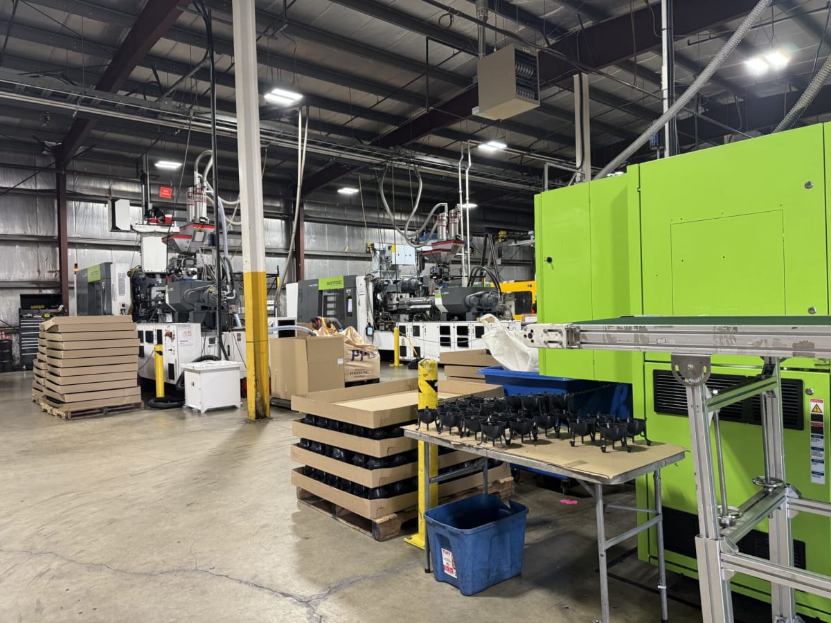 Recycled plastic components arranged in ellipsoid lattice pattern for concrete-reducing building system