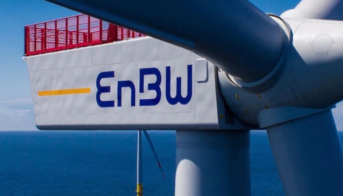 Wind turbines spinning against blue sky in renewable energy farm generating clean electricity