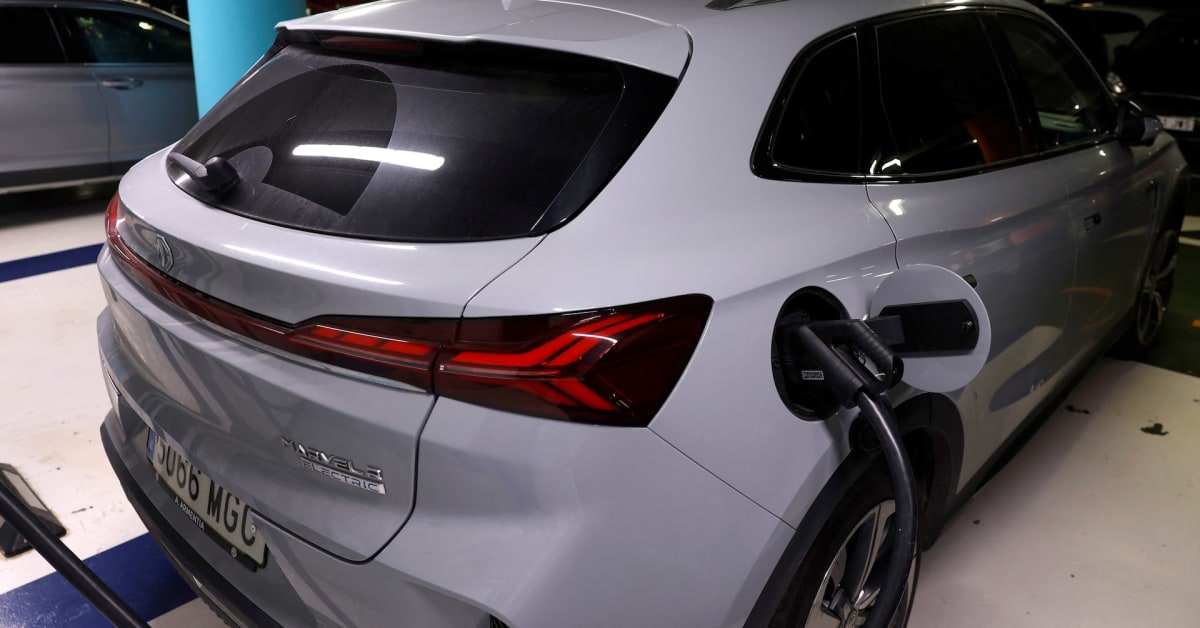 Electric vehicle charging at a public charging station in European car park