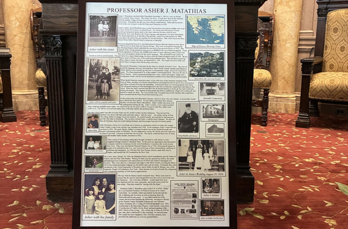 Elderly Holocaust survivor Professor Asher Matathias speaking at podium during Rockaway community remembrance ceremony