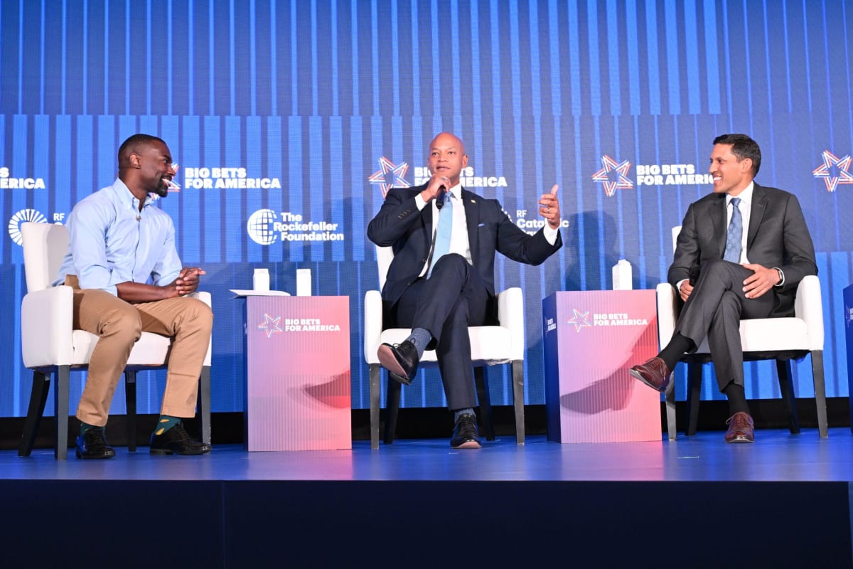 Business leaders and government officials shaking hands at Baltimore economic development summit