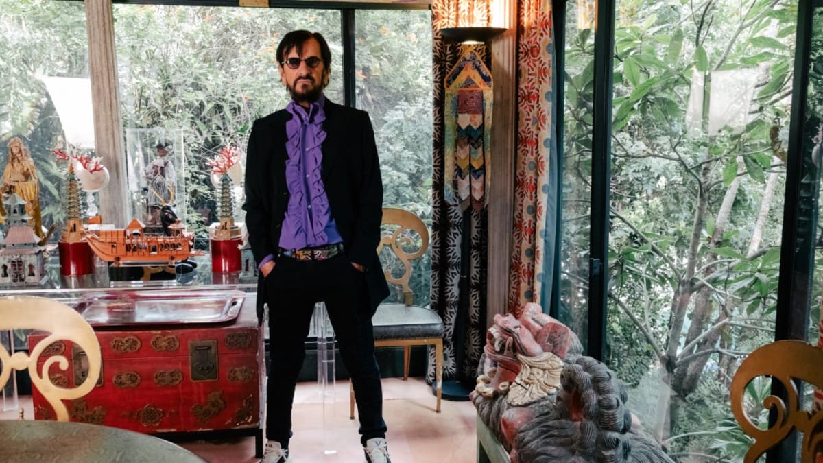 Ringo Starr smiling while holding drumsticks in a Nashville recording studio