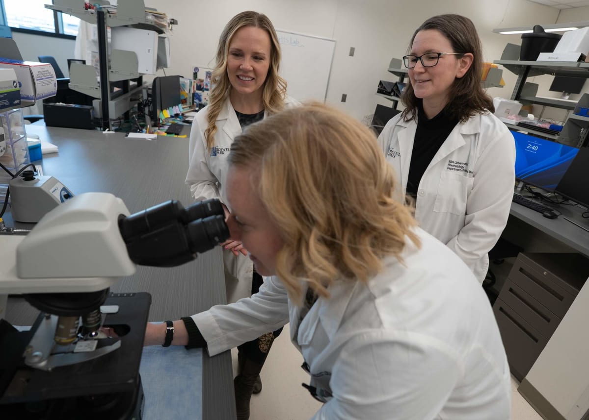 Medical researcher examining cellular samples in a state-of-the-art laboratory clean room facility