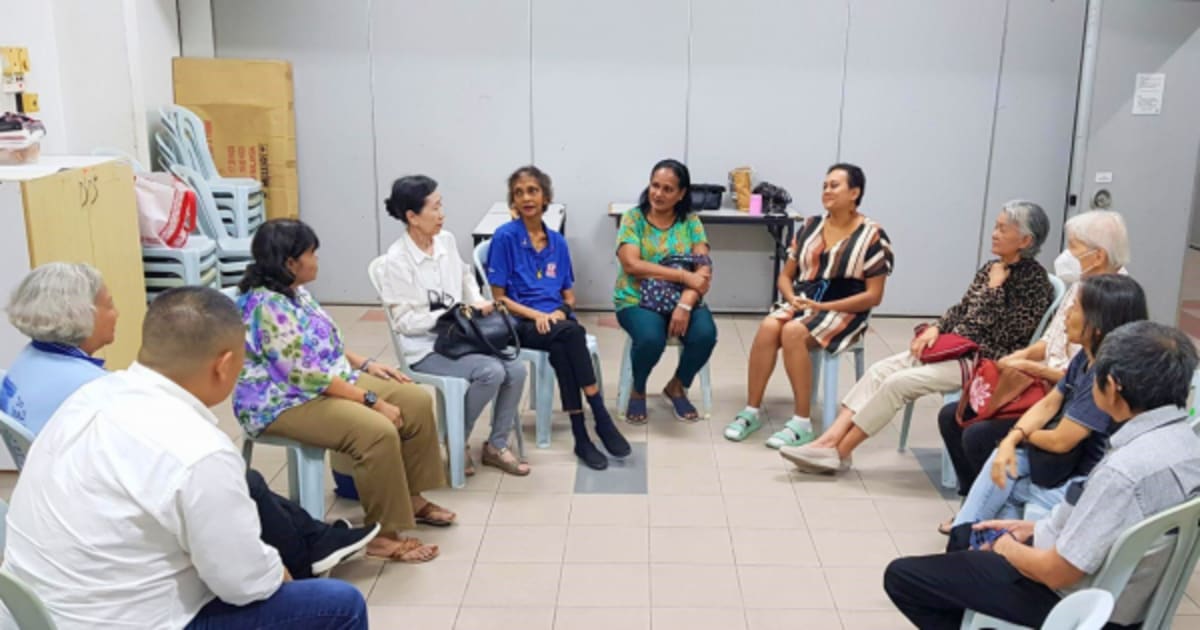 Cancer survivors gather in circle at St. Ignatius Church support group meeting in Malaysia