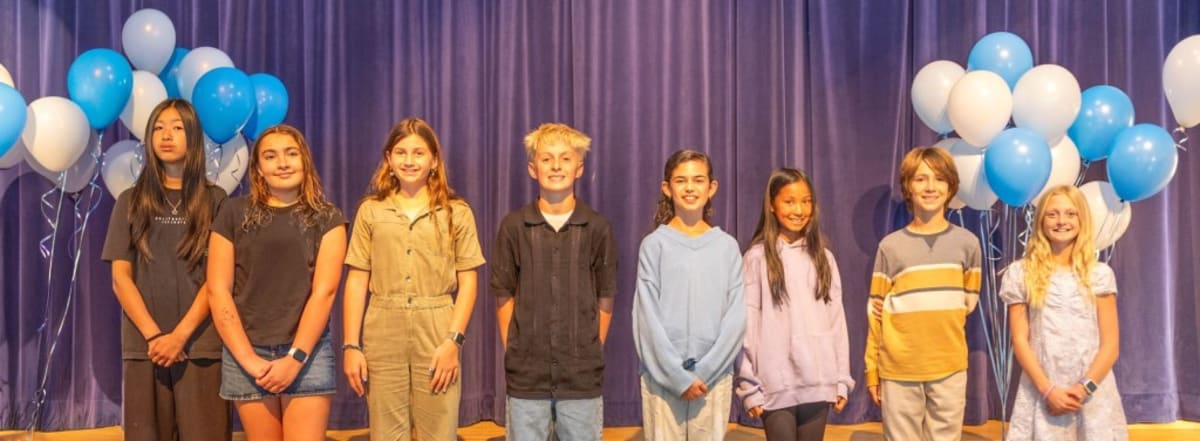 Group of smiling Del Mar student award winners standing together at school celebration ceremony